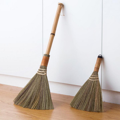 old fashioned straw broom with straw handle